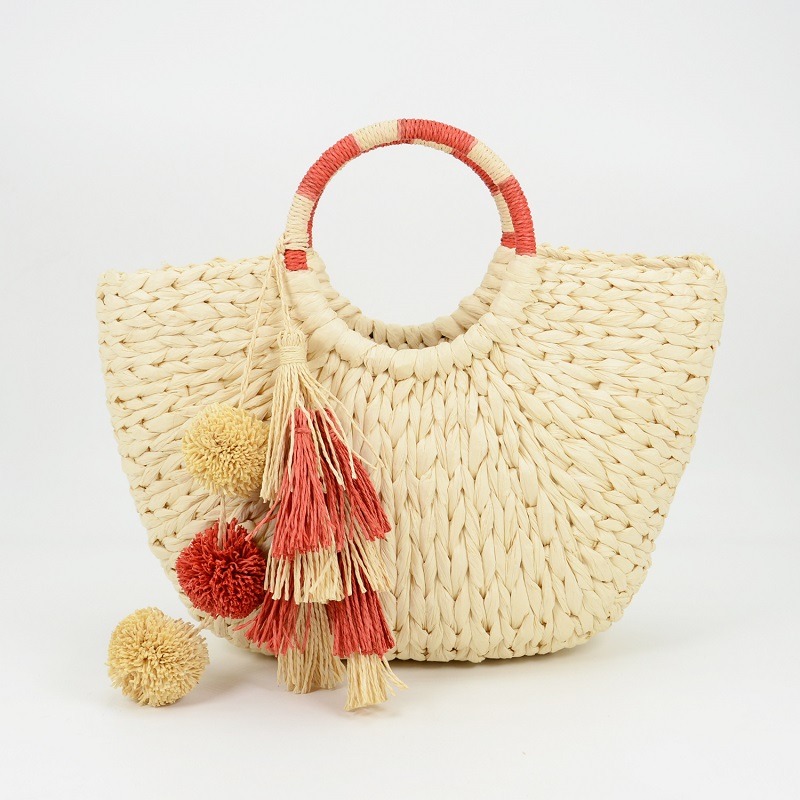 Hoop-handle straw tote with poms and tassels